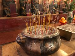 03A Incense sticks in an ornate gold pot urn in front of the 10 gods of hell to the left of the main entrance to Man Mo Taoist Temple Hong Kong
